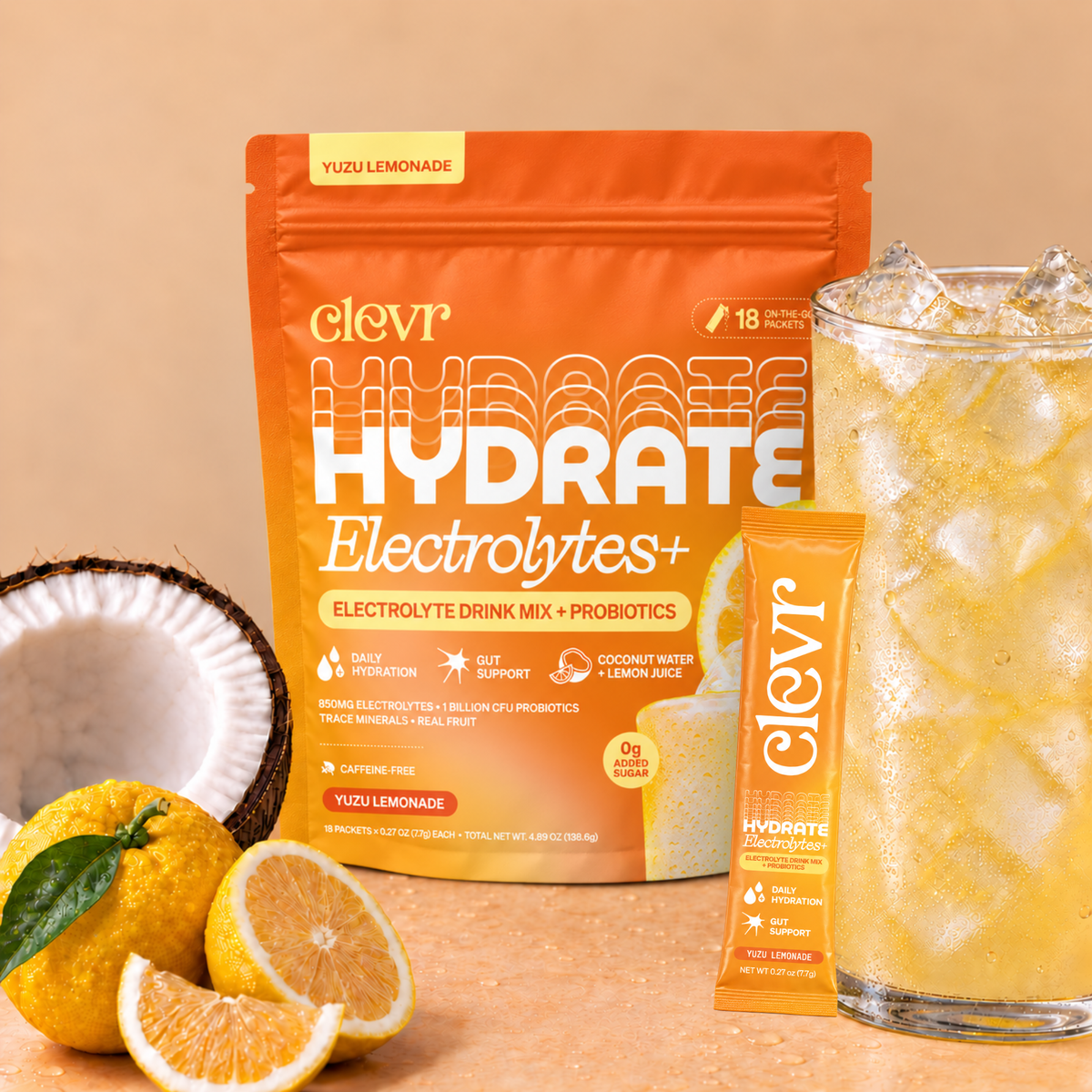 Clevr Hydrate Yuzu Lemonade Pouch surrounded with fruit and an iced drink glass.
