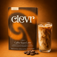 A package of Clevr Coffee SuperLatte stands next to a glass of iced coffee latte with swirls of cream, with a few coffee beans in front, on a warm brown background.