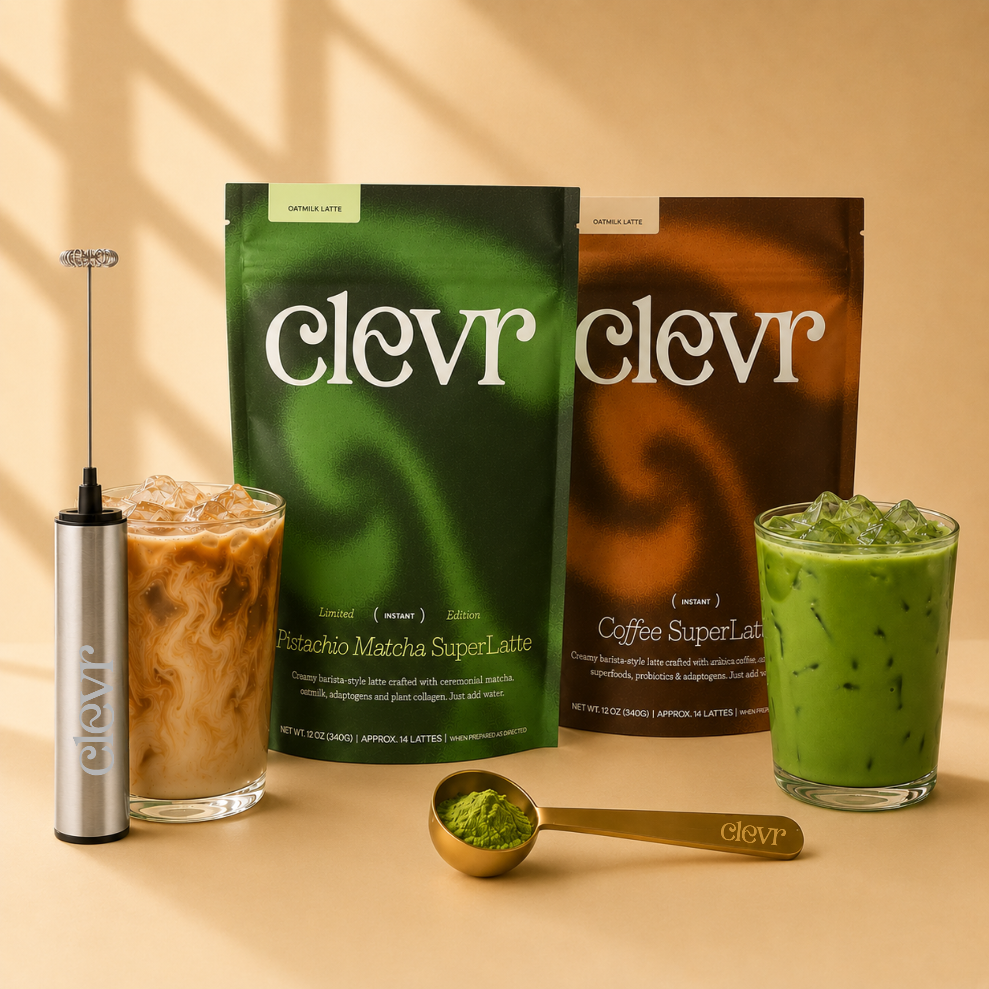 Two Clevr branded pouches of matcha and coffee latte mix are displayed with prepared iced drinks and a small gold measuring spoon on a warm beige background with soft shadow overlays.