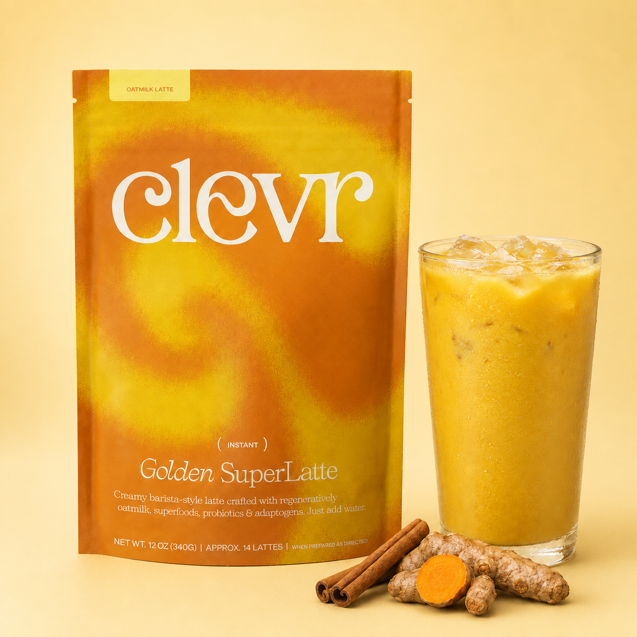 A stand-up pouch of Clevr Golden SuperLatte next to a tall glass of iced golden latte, with cinnamon sticks and a turmeric root on a warm beige background.