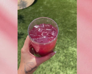 video of woman enjoying supertea in a glass with ice talking about the product highlights