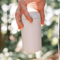Hand holding Clevr thermos outside